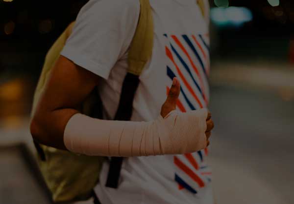 Person with forearm and hand bandaged giving the thumbs up sign
